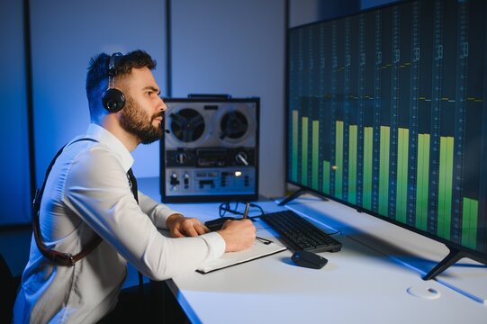 Secret agent listens on the reel tape recorder. Officer wiretapping in headphones