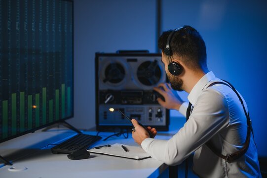 A police officer records a telephone conversation on a tape recorder. secret agent