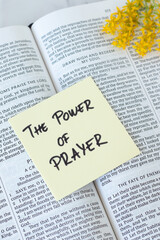 Obraz premium The power of prayer, handwritten text on a note with holy bible book. Christian biblical concept.