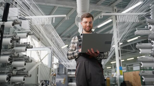 Factory engineer using laptop inspecting polypropylene production line