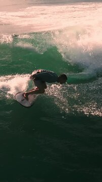 Aerial Male Surfer Riding Turquoise Wave Carving Face Of Perfect Bali Swell In Slow Motion,Bali,Indonesia