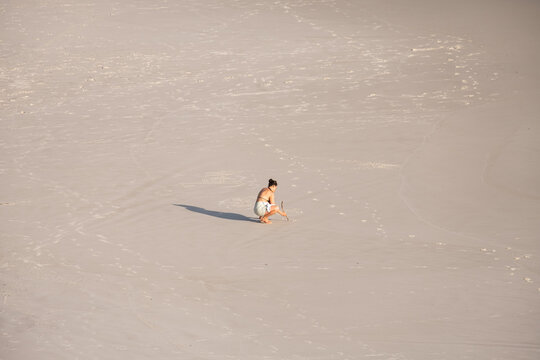 Arraial Do Cabo, Brasil - Mujer dibujando en la arena en un d&iacute;a de verano.