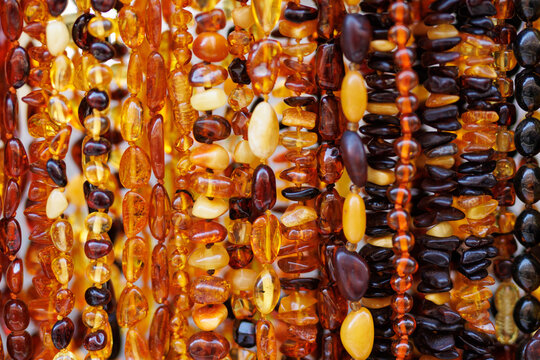 Close up of colorful amber necklaces on display at Polish market