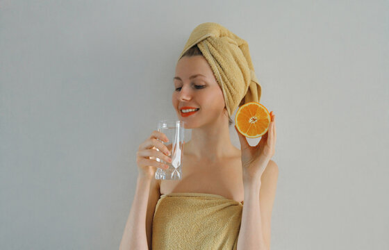 Beauty, nutrition, diet. Happy woman drinks clean water holds fruits
