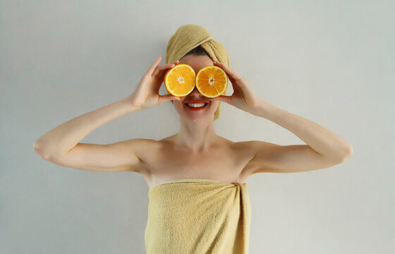 Beauty, nutrition, diet. Happy cheerful woman holding orange fruits