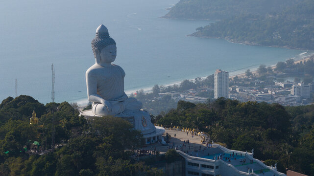 Aerial view of the Big Buddha Phuket statue on Nakkerd Hill overlooking the Andaman Sea and coastline with people on the observation deck Karon, Phuket, Thailand.