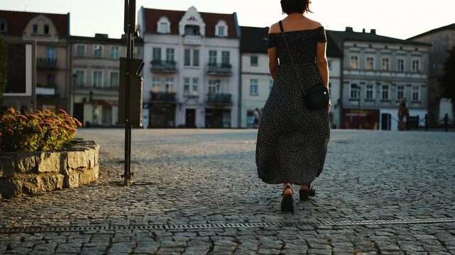 Young Attractive Woman, A Female Tourist, Walks Through The Historical Part Of A European City And Down An Old Street