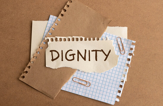 the word dignity in a rustic wooden split flap board.