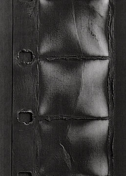 Dark burned 16mm film strip printed on paper with distressed analog texture and vintage cinema aesthetic.