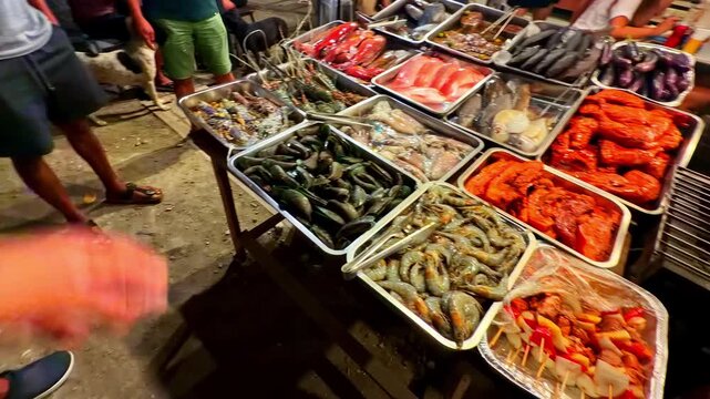Fresh seafood displayed on market table with fish and shellfish in Port Barton Philippines