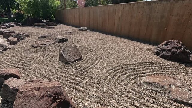 Tranquil Zen dry landscape garden featuring large rocks and raked sand ripples, 4K video