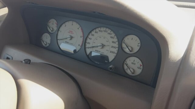 Closeup of car dashboard showing speedometer tachometer and gauges