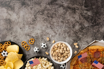 Fototapeta premium Football championship snacks spread with pizza, popcorn, pistachio, chips and pretzels for game day