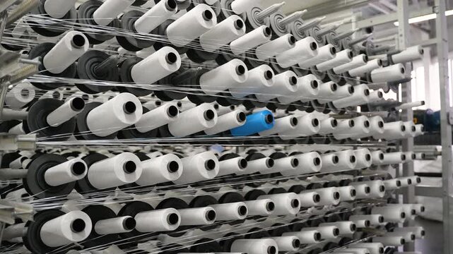 Industrial textile machine weaving polypropylene threads in a factory