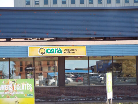 Gatineau, Quebec, Canada &ndash; April 18, 2026: A "Cora" breakfast and lunch restaurant storefront featuring the iconic sun logo at 200 Bd Gr&eacute;ber.