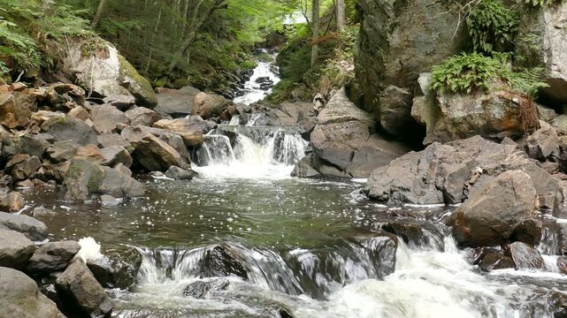 Iroquois Falls on a small river with rapids and a waterfalls along Sentier Iroquois, a hiking trail near Lac Simon in Duhamel, Quebec, Canada.
