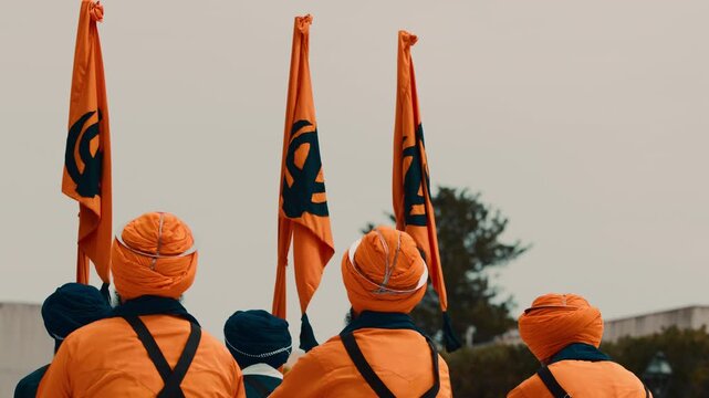 Indian devotees during the Vaisakhi celebration of the Sikh with orange flag