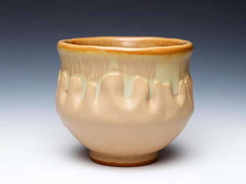 Textured stoneware cup with an organic, lumpy silhouette and earthy glaze tones,  earthy,  unique