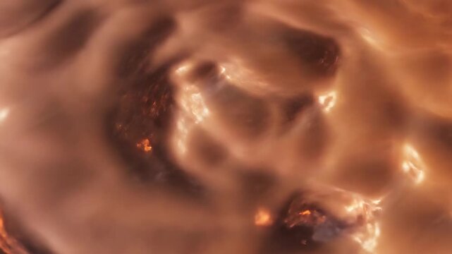 Warm copper brown boiling liquid surface with bubbling texture in abstract loop