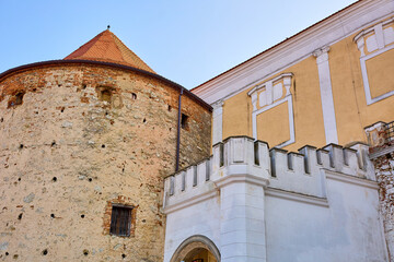 Historic stone tower and castle wall against clear blue sky © Iurii Gagarin