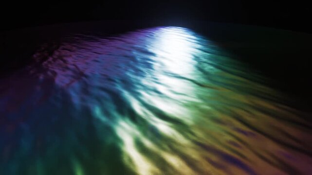 Colorful spotlight beam glowing on dark floor with rainbow gradient light loop
