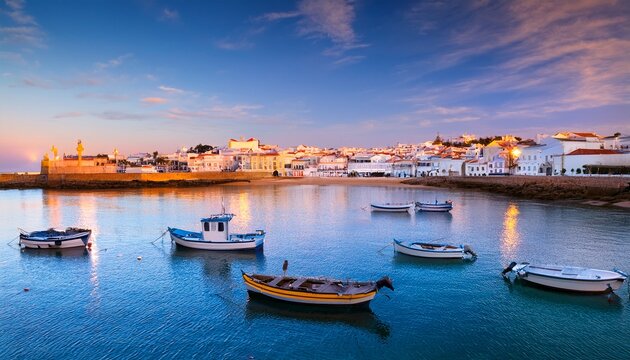 ferragudo fishing village evening summer view with boats on water travel destination in portugal algarve