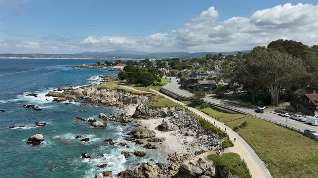 Pacific Grove, California, USA - Cinematic Drone Flying Forward Along Rocky Coastline and Scenic Oceanfront Homes