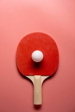 Ping pong rackets and balls on pink background, flat lay
