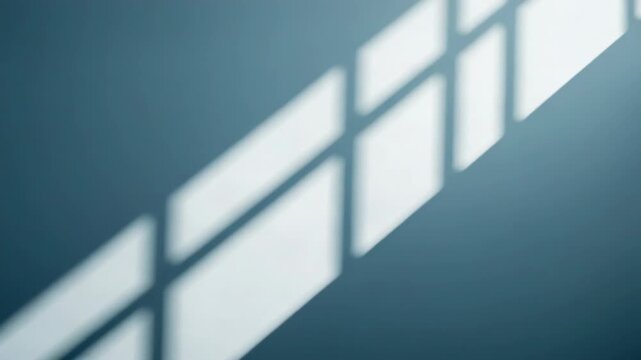 Soft window light geometric shadow on blue wall creating calm minimal mood with grid pattern
