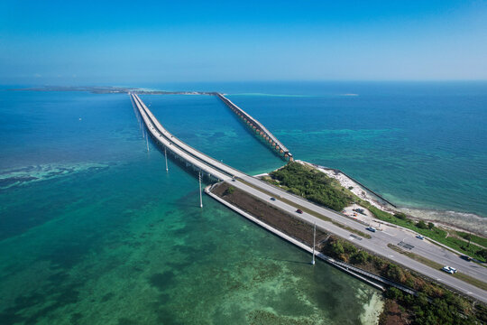 Aerial view of The Overseas Highway stretching across turquoise ocean waters under a clear blue sky Key Largo, Florida, United States.
