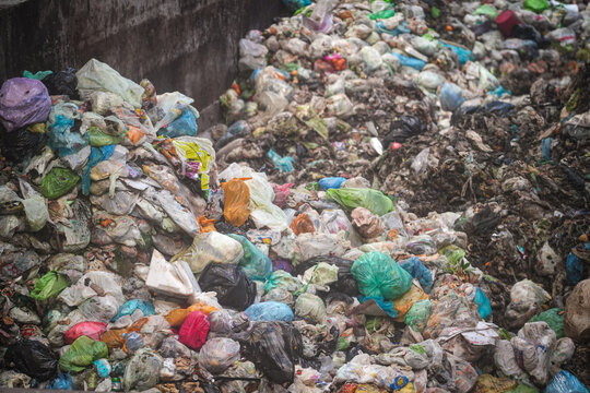 View of large piles of colorful plastic bags and organic waste at the Forsu Iren treatment plant in Reggio nell'Emilia, Emilia-Romagna, Italy.