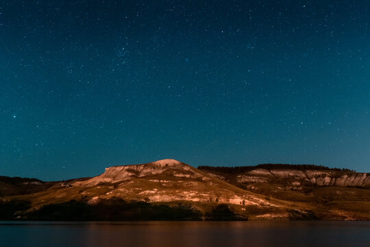 night landscape of a mountain chain on the river bank