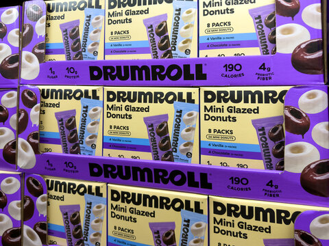 Prosper, Texas, USA - May 06th, 2026: Drumroll mini glazed donuts vanilla and chocolate protein snack boxes stacked at local Costco retail warehouse
