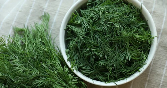 Fresh green dill on table, top view. Camera spinning