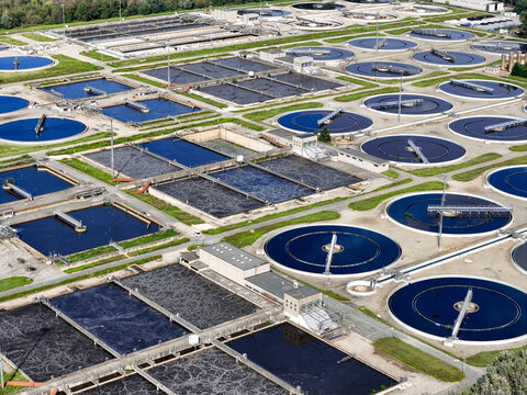 Aerial view of the Impianto depurazione wastewater treatment plant with circular sedimentation tanks and rectangular basins in Castiglione Torinese, Piedmont, Italy.
