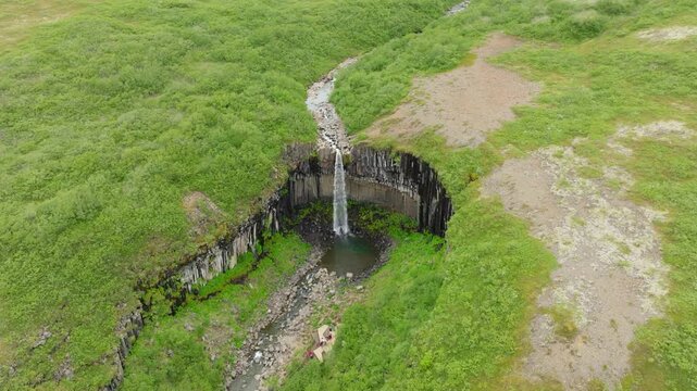 Famous and beautiful Svartifoss waterfall on a summer day in south Iceland. Located in Skaftafell in Vatnaj&ouml;kull National Park. Surrounded by dark lava columns and sharp rocks.