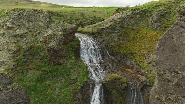 Aerial flight over the beautiful Systravatn\Systrafoss waterfall on a summer day in south Iceland. It is located in a small forest close to Kirkjub&aelig;jarklaustur.