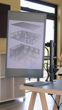 Vertical video: Shifting camera right to reveal vertical monitor at studio with arm, cables