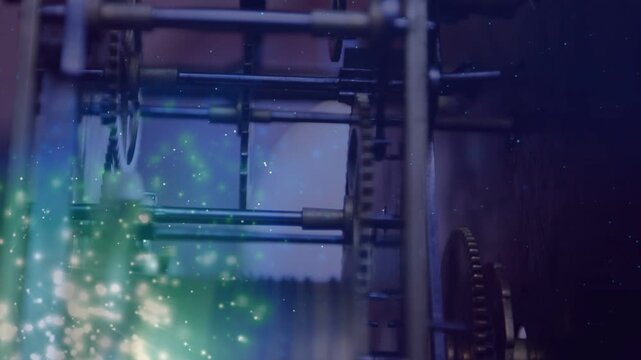 Green particle glow appearing lower-left and initiating ribbed drum rotating, engaging large cog