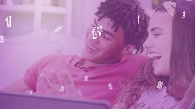 Couple reacting to laptop while showing numbers overlay and he gesturing phone, tech
