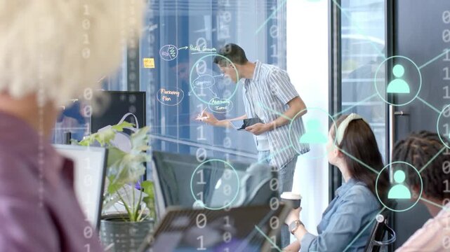 Presenter tapping tablet, drawing diagram on glass, creating data overlays for project planning