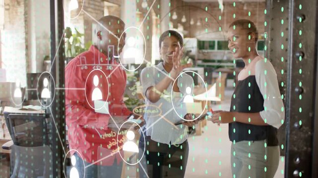 Center lead raising hand causing growing network tech on glass, team tapping nodes agreeing plan