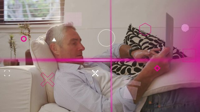 Man reclining on sofa tapping touchscreen to check tech feed, magenta graphics shifting over screen