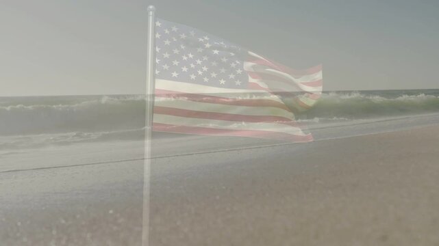 Gusty breeze driving translucent US flag flapping while waves rising breaking into foam on shore