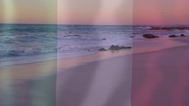 Shoreline and surf advancing and retreating from swell, bands shifting, mirroring pastel dusk
