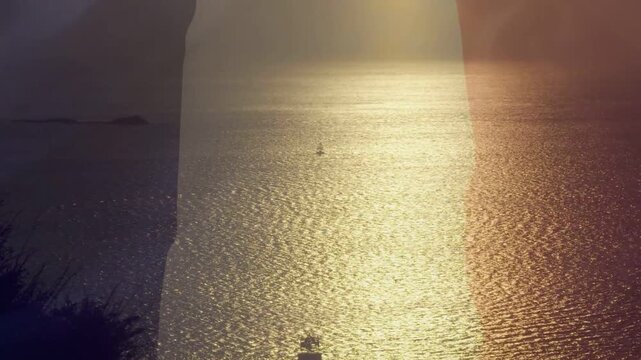 Overlay appearing right causing sunlit sea reflecting, widening gold path, boats moving, warming