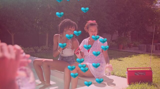 Two women pool toasting as drink entering, reaching red cooler, dancing with floating hearts social