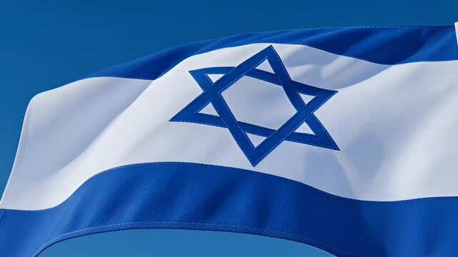 The Israeli flag waves gently against a clear blue sky backdrop