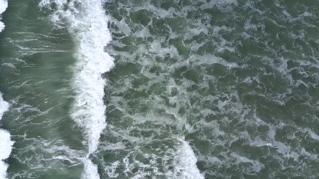 Top‑Down View of Powerful Ocean Waves Crashing and Foaming