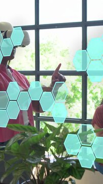 Vertical video: Woman standing with VR headset raising hands, selecting hex UI for tech test